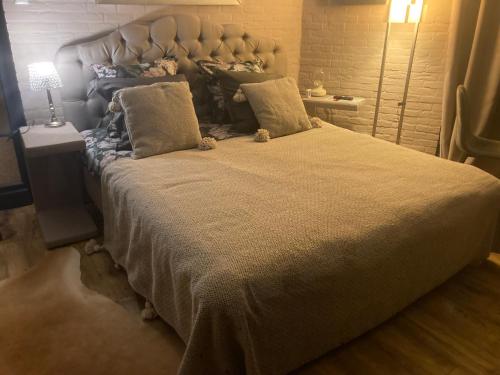 a bedroom with a large bed with a teddy bear on it at Canal Central in Bruges