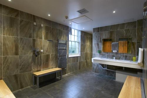 a large bathroom with a sink and a shower at Avisford Park Hotel in Arundel