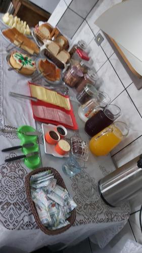 a table with a bunch of food and drinks on it at Hotel Pousada Girassol in Matinhos