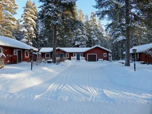 a red cabin with snow on the ground in front at Sifferbo Stugby in Sifferbo