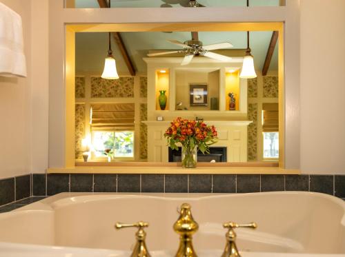 a bathroom with a tub and a large mirror at Woolverton Inn in Stockton