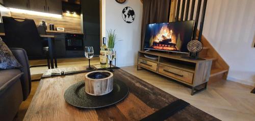 Televisyen dan/atau pusat hiburan di Sjesta al mare, domki z sauną i balią z jacuzzi