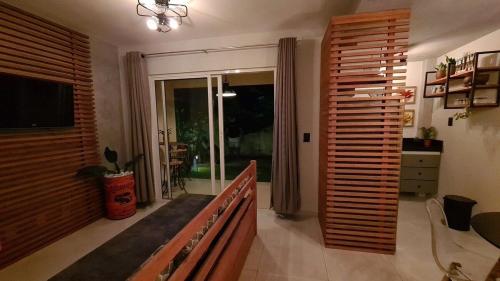 a living room with a couch and a sliding glass door at Solar Águas Pipa Prime in Pipa