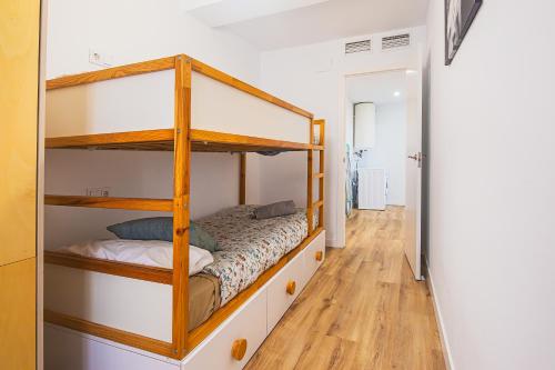 a bedroom with two bunk beds and a wooden floor at CARTAGENAFLATS, Apartamentos Anfiteatro Romano 4C in Cartagena