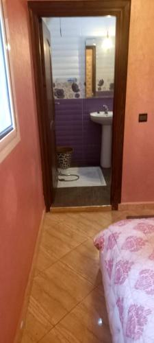 een kamer met een badkamer met een wastafel en een spiegel bij Villa à louer dans un endroit magnifique in Tifnit