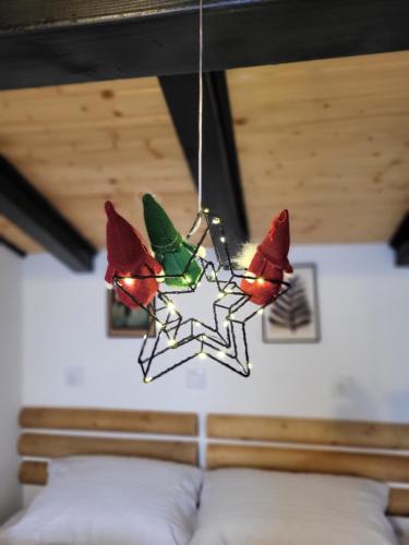 a glass bird chandelier hanging over a bed at HUUT in Zlatibor