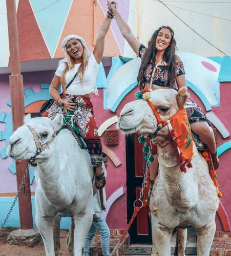 two women riding on the backs of horses at HoneyMoonnaka Guest House Nubian ( بيت هانى ) in Aswan