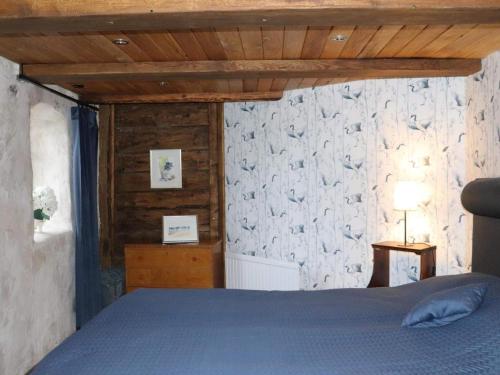 a bedroom with a bed and a stone wall at Holiday home SIMLÅNGSDALEN IV in Simlångsdalen