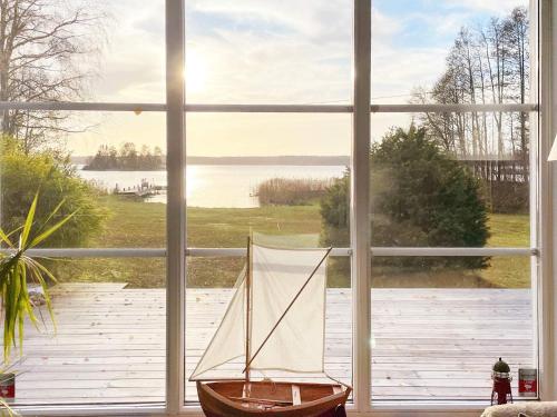 a window with a sail boat sitting inside of it at 5 person holiday home in BJÖRKÖ-By Traum in Björkö