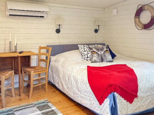 a bedroom with a bed with a cat sitting on it at 5 person holiday home in BJÖRKÖ-By Traum in Björkö