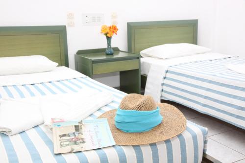 a hat sitting on top of two beds at ilissos Apartments in Stalida