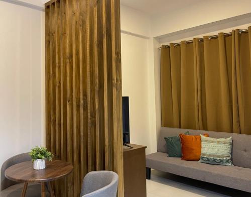 a living room with a couch and a table at Airo Suites Makati in Manila