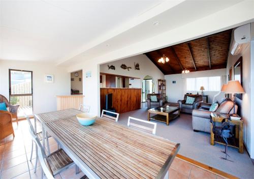 a living room with a table and a couch at Views Over Russell in Russell