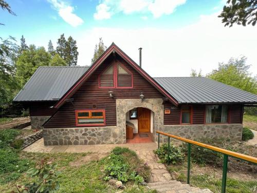 una casa con techo de gambrel con piedra en Casa Otto en San Carlos de Bariloche