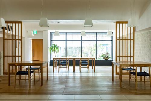 a dining room with wooden tables and chairs at Sensui in Toyooka