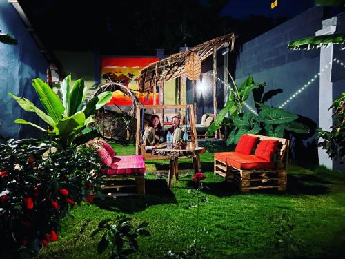 a garden with two chairs and a person sitting on a swing at Serengeti Villa in Arusha