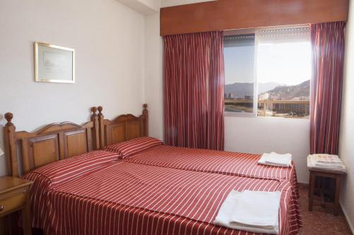 Posteľ alebo postele v izbe v ubytovaní Apartamentos Florazar II Ajhory