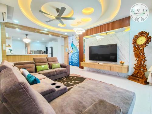 a living room with a couch and a flat screen tv at Pangsapuri Meridian by RR JBcity in Nusajaya