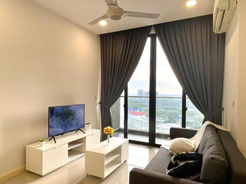 a living room with a couch and a large window at D'pristine by Antlerzone in Johor Bahru