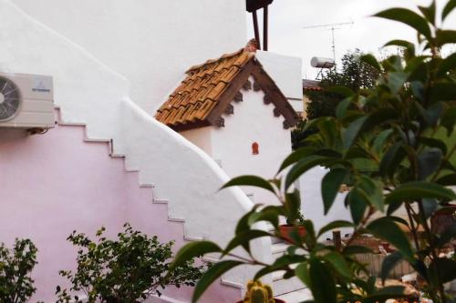 a staircase with a roof on the side of a building at Marco Polo's Mooring Cozy Navy House in Anavissos
