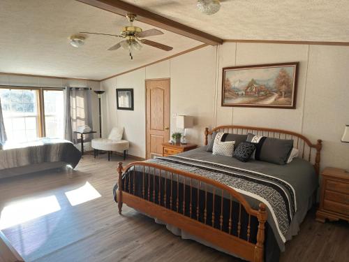 a bedroom with a bed and a ceiling fan at Spacious Cozy Getaway ! King Bed, Game Room, Out Door Patio in Cairo