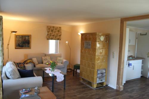a living room with a couch and a table at Gut Settin am See - Ferienhäuser in Settin