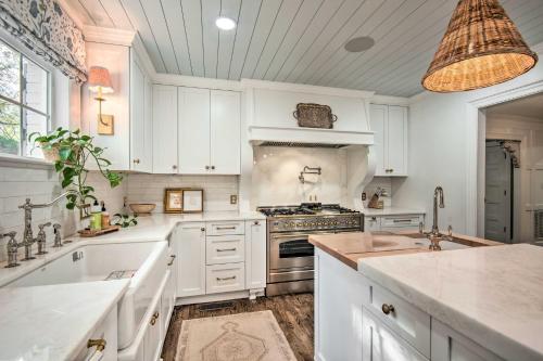 a kitchen with white cabinets and a stove top oven at Stunning Charlotte Home Private Pool! in Charlotte