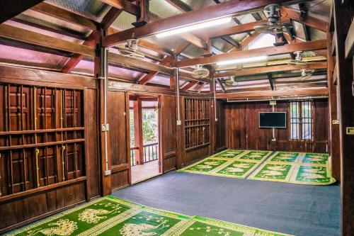 a room with wooden walls and a flat screen tv at SAKURA House - Hoa Ban in Mộc Châu