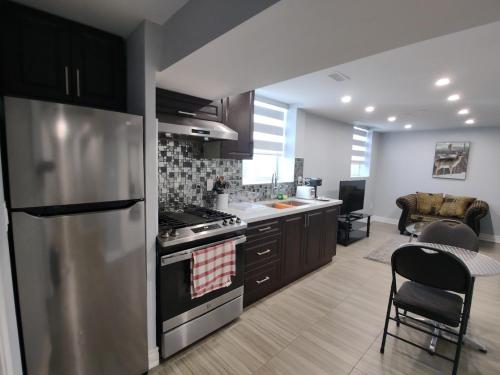 a kitchen with stainless steel appliances and a dining room at Prestige Accommodation Self-contained 2 Bedrooms Suite in Ajax