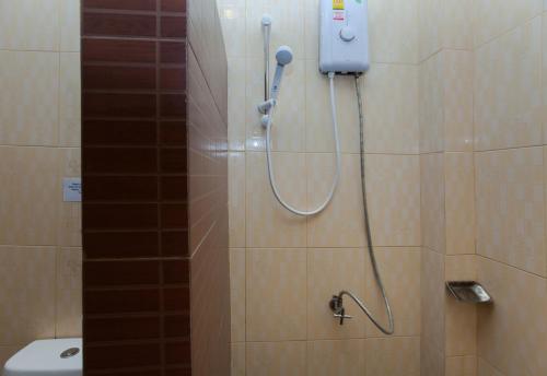 a shower in a bathroom with a toilet at Lanta Riviera Resort - SHA Extra Plus in Ko Lanta