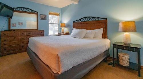 a bedroom with a bed and a dresser and a mirror at Embarcadero Resort in Newport