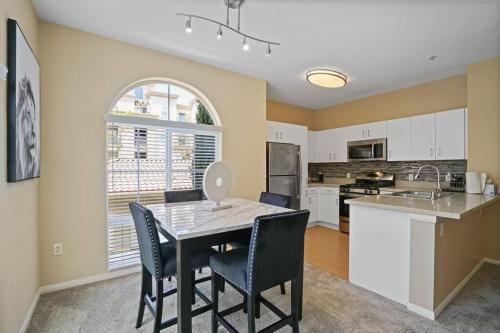 a kitchen and dining room with a table and chairs at Luxury 2BR/2BA!5Min to Disney! Angelstadium! HondaCenter. in Anaheim