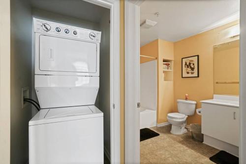 a bathroom with a white refrigerator and a toilet at Luxury 2BR/2BA!5Min to Disney! Angelstadium! HondaCenter. in Anaheim