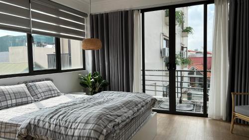 a bedroom with a bed and a balcony at The Hive Homestay in Hanoi