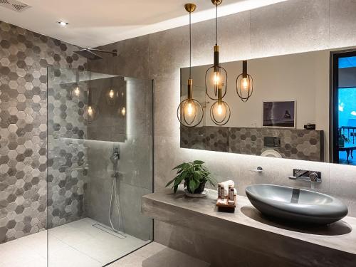 a bathroom with a sink and a shower at Nuuk Taal Lake in Laurel