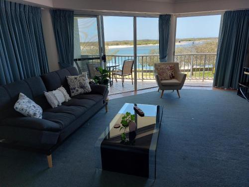 a living room with a couch and a table at Sandy Shores Holiday Units in Caloundra