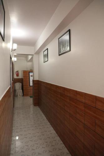a long hallway with wood paneling on the wall at Matina Regency in Gangtok