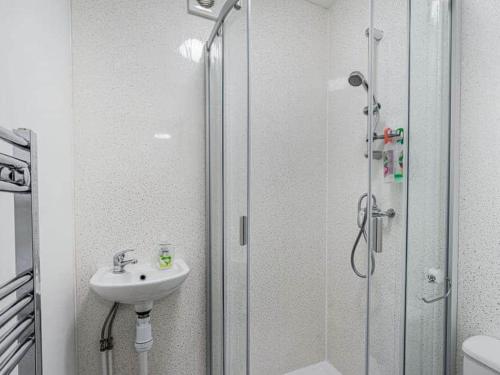 a bathroom with a sink and a glass shower at Numero Uno Detached Aparthouse in Newcastle upon Tyne