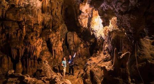 a group of people standing in a cave at Thao Ly Homestay Mai Chau in Hòa Bình