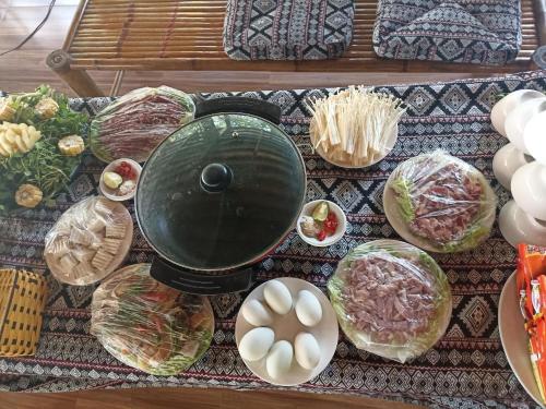 a table topped with different types of food at Thao Ly Homestay Mai Chau in Hòa Bình