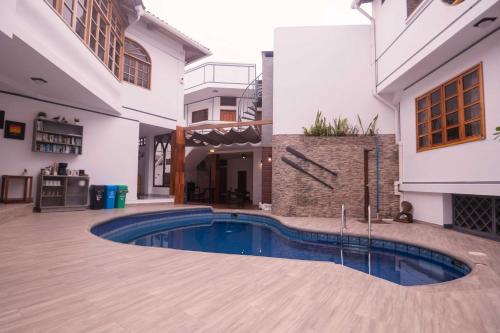 a swimming pool in the middle of a house at Hotel Santa Fe in Puerto Ayora