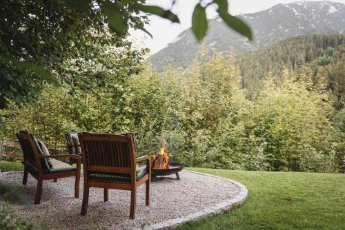 two chairs and a fire pit in a yard at Ferienwohnung Waldgarten in Leiten
