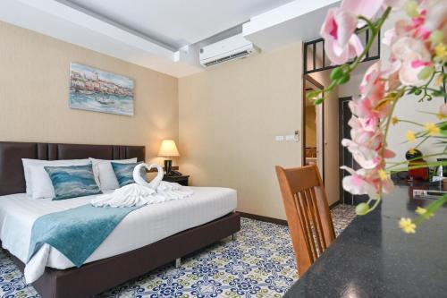 a bedroom with a bed with a swan on it at Aranta Suvarnabhumi in Lat Krabang