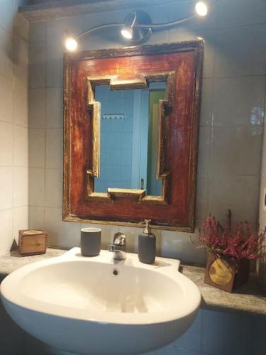 a bathroom with a white sink and a mirror at Appartamento sotto la Mole Antonelliana in Turin