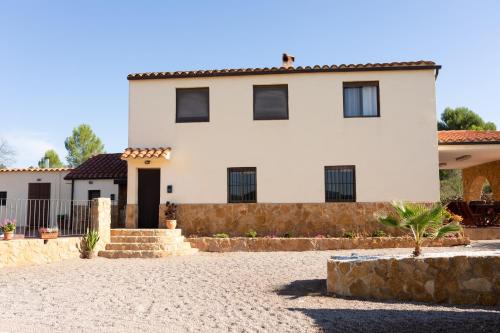 a white house with black windows at EL NIU DELS PAPUTS in Castellón de la Plana
