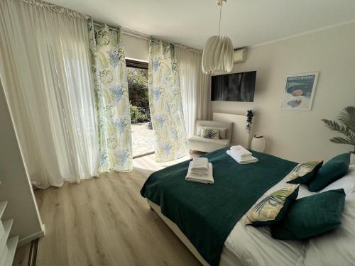 a bedroom with a large bed and a window at Fantastic villa in the bay of Cannes, 5 minutes from the beach - with private pool in Mandelieu-la-Napoule