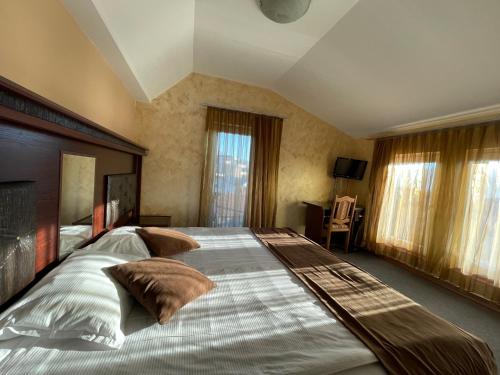 a large bedroom with a large bed with pillows at Meka Hotel in Dragash