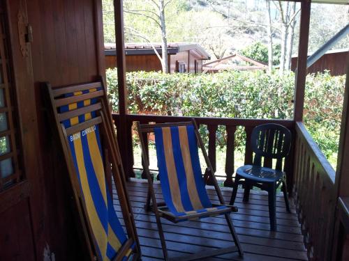 two chairs sitting on the porch of a house at Villaggio Camping Valdeiva in Deiva Marina