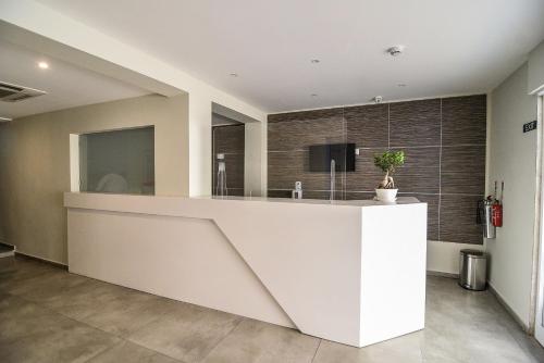 a kitchen with a white counter in a room at The Howard Hotel in Sliema