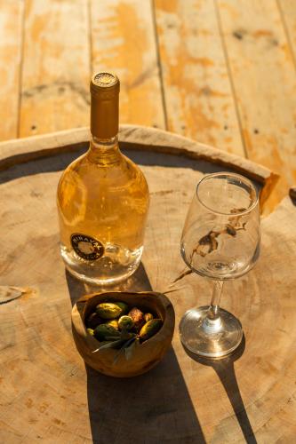 a bottle of wine and a glass on a table at Meli Suites Isle - Adults Only in Skala Potamias